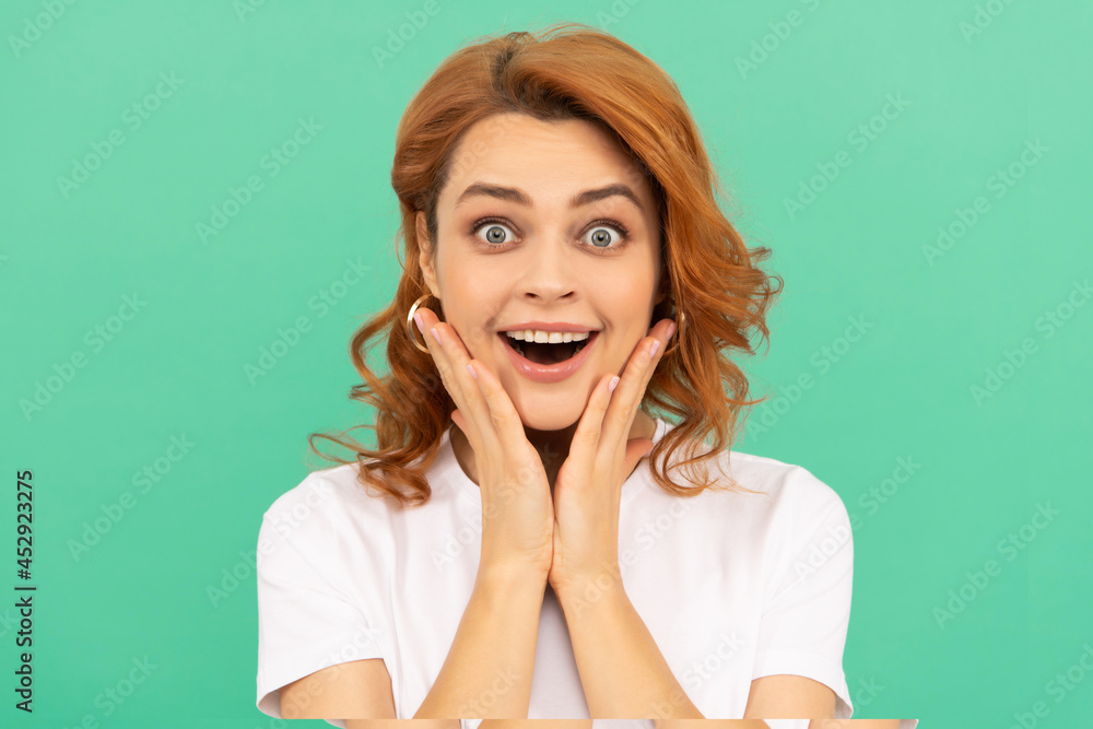 surprised redhead girl with curly hair and healthy skin on blue background, surprise surprised redhead girl with curly hair and healthy skin on blue background, surprise