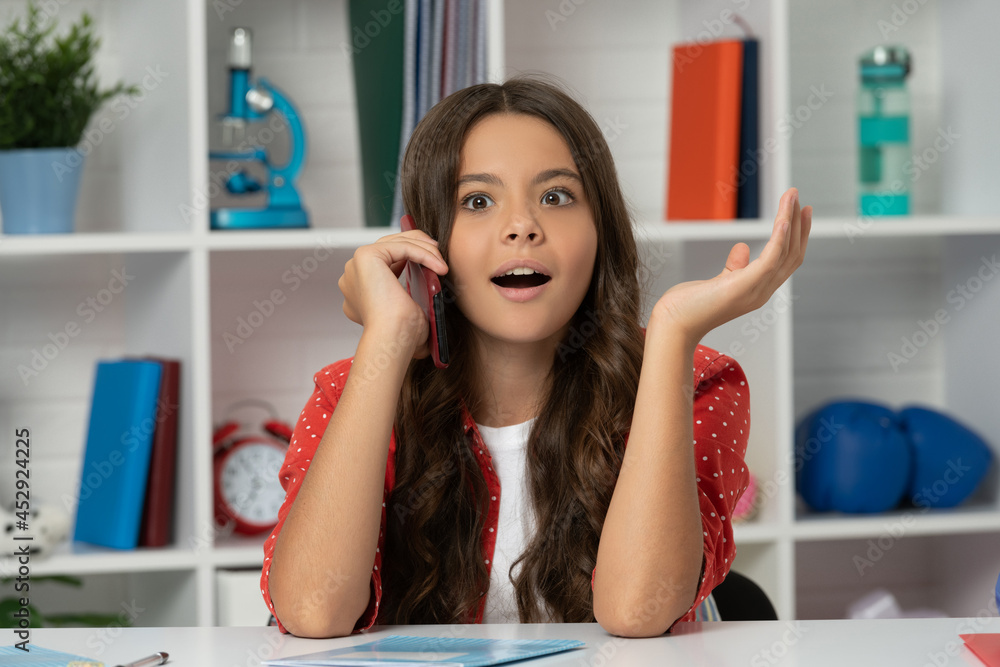 amazed child curly hair talking on phone in classroom, conversation amazed child curly hair talking on phone in classroom, conversation