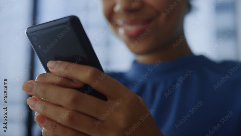 Closeup smartphone in woman hands. Happy business woman using mobile phone