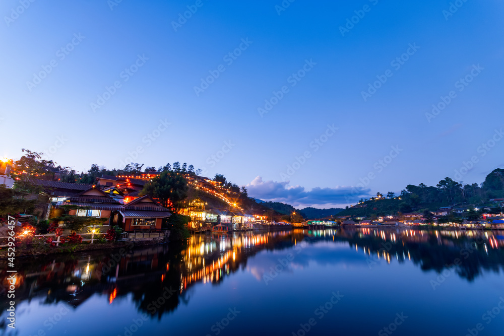 beautiful sunsets view of Ban rak thai, Mae Hong Son, Thailand. The dusk scene after sunset with the reflection of the buildings and night market 