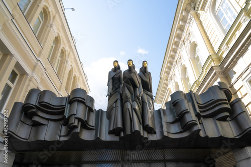 three statues with the golden mask in vilnius