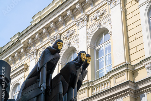 three statues with the golden mask in vilnius