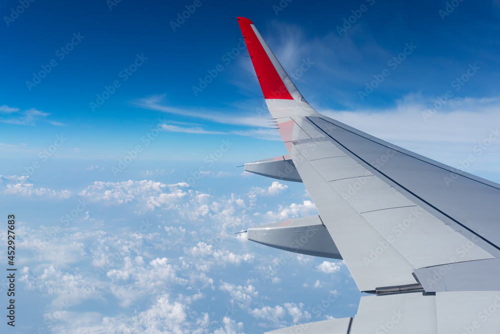 Air Plane wing on the blue sky and clouds can be used for air transport to travel and open season to travel background Summer season concept.