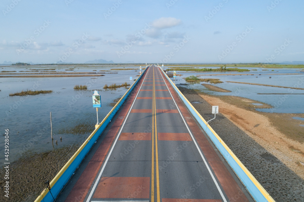 Aerial view Drone shot of Bridge(Ekachai bridge)Colorful Road bridge cross the lake at Talay Noi Lake in Phatthalung province Thailand. Aerial view Drone shot of Bridge(Ekachai bridge)Colorful Road bridge cross the lake at Talay Noi Lake in Phatthalung province Thailand.