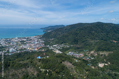 Aerial view blue ocean and blue sky with mountain in the foreground at Patong Bay of Phuket Thailand Landscape of patong city phuket in sunny summer day time Beautiful tropical sea High angle view.
