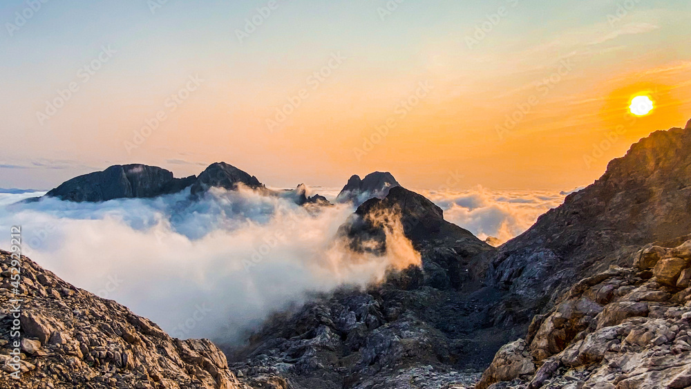 Sunset in the mountains upon the clouds with beautiful light and colors, Picos de Europa 