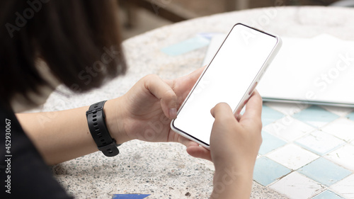 Wallpaper Mural Woman's hands holding or using smartphone with two hands. Smartphone with white blank on screen, Cellphone mockup. Torontodigital.ca