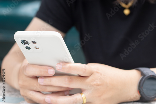 Wallpaper Mural Close up of woman hand holding and using smartphone. Torontodigital.ca