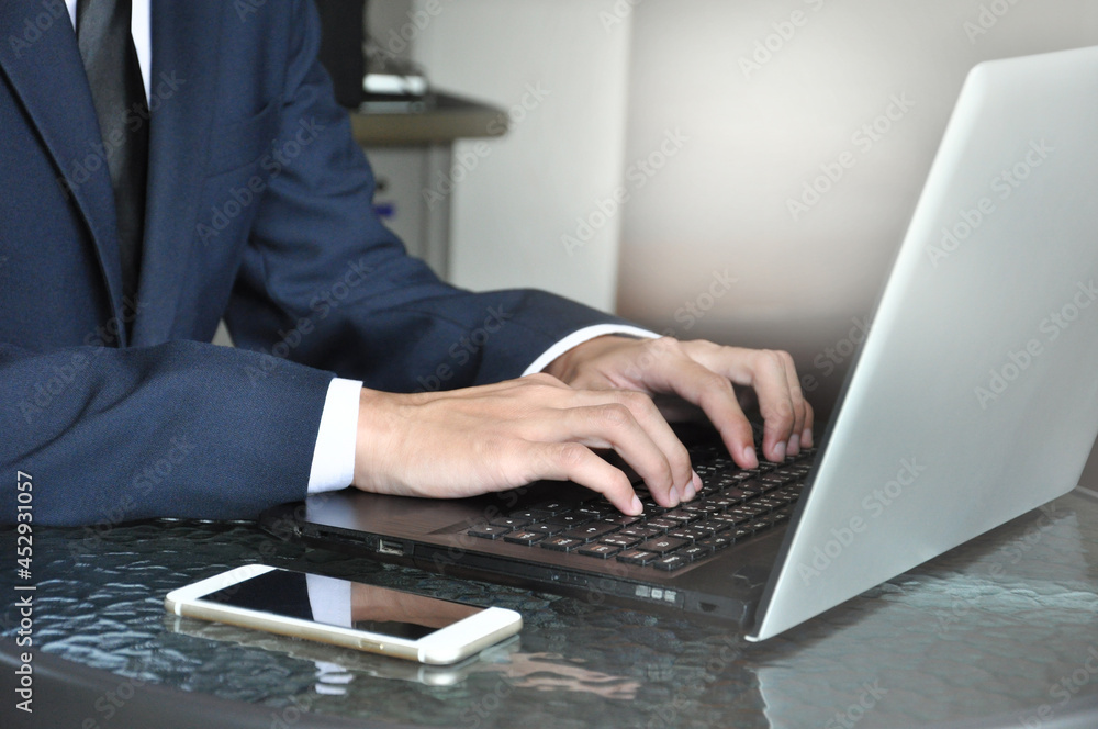 man in business suit typing laptop, selective focus man in business suit typing laptop, selective focus