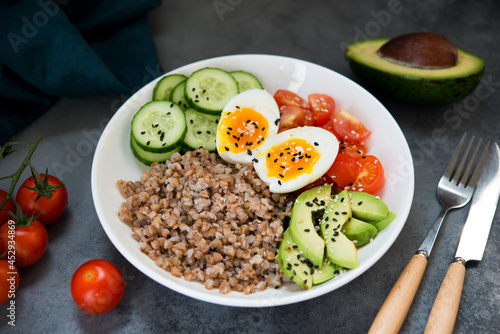 Buddha bowl with vegetables, buckwheat tomatoes and avocado, healthy food