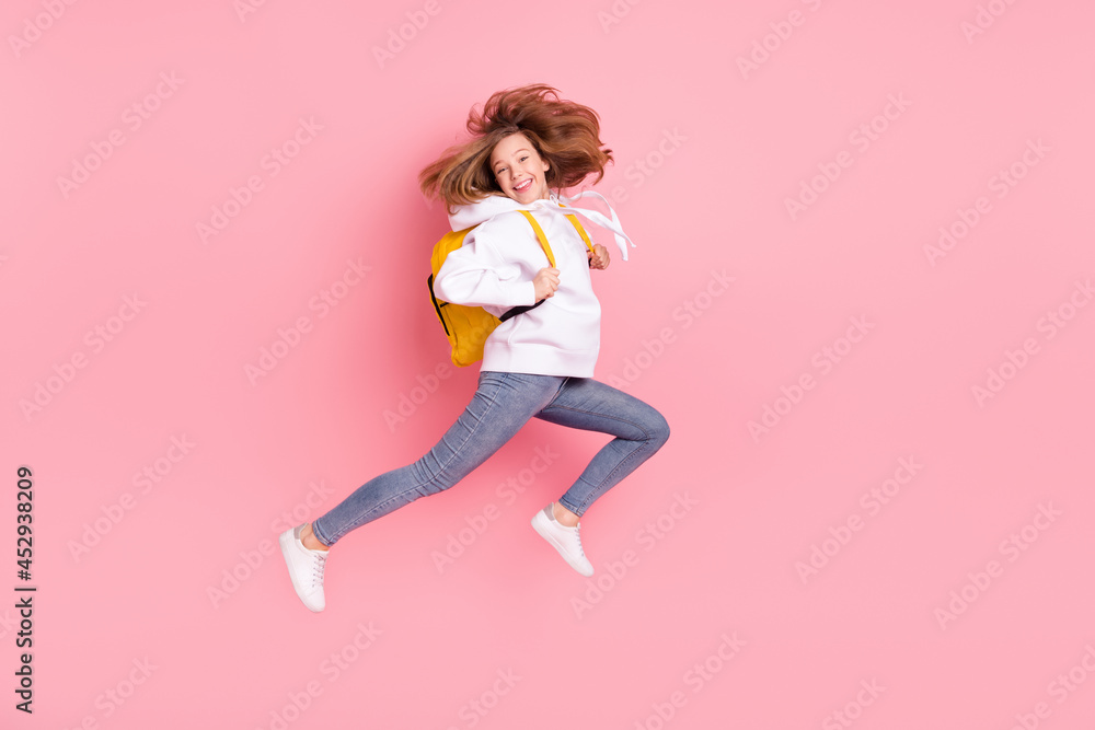 Full length body size view of pretty glad cheerful motivated girl jumping running having fun isolated over pink pastel color background