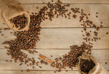 Coffee beans in a mug, a cup of coffee full of coffee beans, coffee cup with roasted beans on a wooden background. Copy space