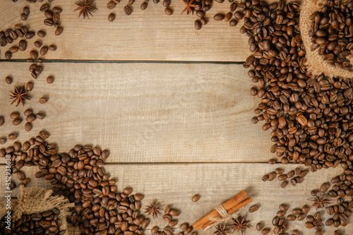 A cup of coffee. with roasted grains on a wooden background. Top view with copy space for your text. Coffee beans on wooden background. View from above.