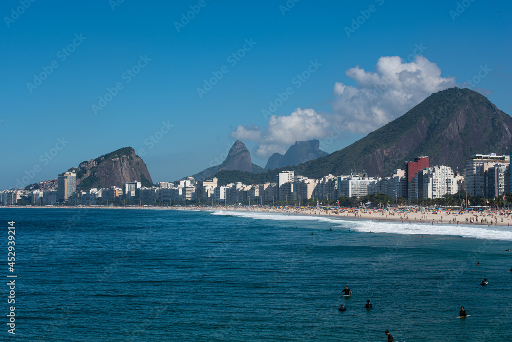 Walking through the beautiful beach of Copacabana Walking through the beautiful beach of Copacabana