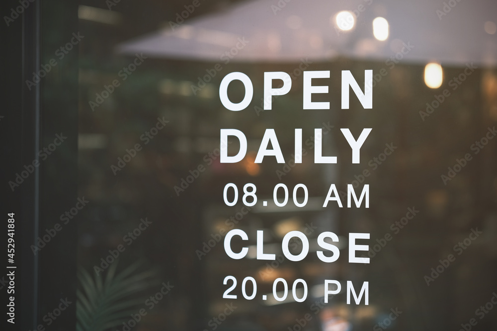 Obraz premium Opening sign hanging front of cafe with colorful bokeh light abstract background, protection to pandemic of coronavirus reopen store, restaurant after close lockdown quarantine in covid.