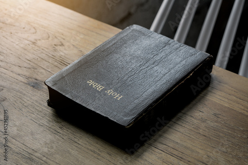 The Holy Bible is on a wooden table.Religion concept