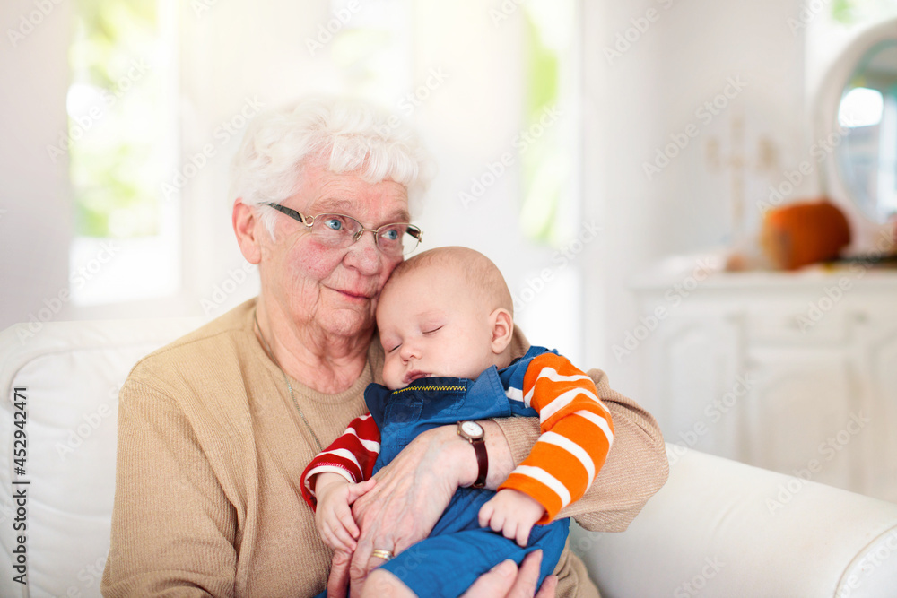 Grandmother holding newborn baby. Family reunion. Grandmother holding newborn baby. Family reunion.