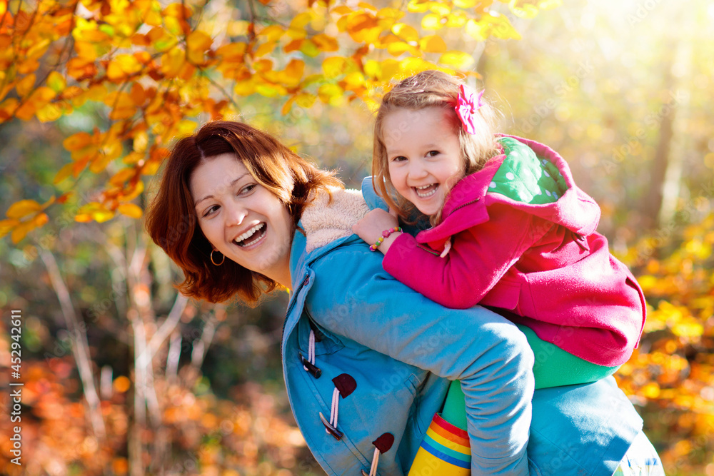 Mother and kid in autumn. Fall outdoor family fun. Mother and kid in autumn. Fall outdoor family fun.