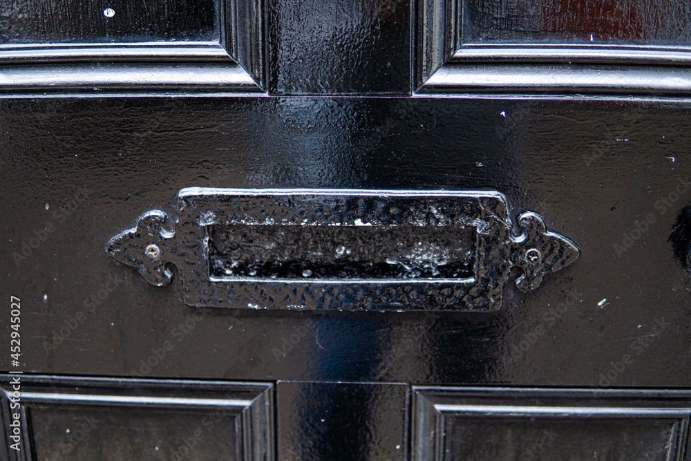 Old letterbox in the door, traditional way of delivering letters to the house, old mailbox, correspondence