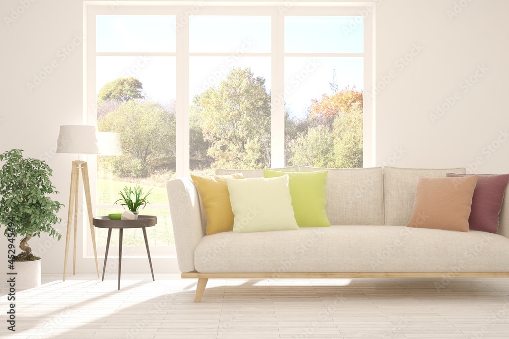 Fototapeta premium Stylish room in white color with sofa and autumn landscape in window. Scandinavian interior design. 3D illustration