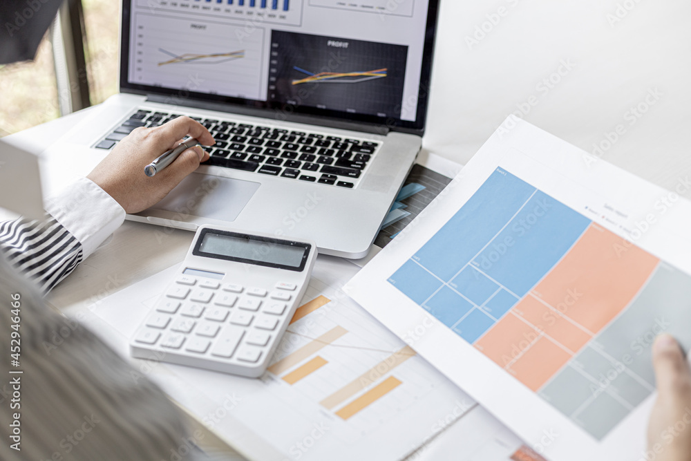 Businesswoman viewing financial data on laptop, she is reviewing financial data to bring to meetings with business partners. Concept of company financial management. Checking financial information. Businesswoman viewing financial data on laptop, she is reviewing financial data to bring to meetings with business partners. Concept of company financial management. Checking financial information.
