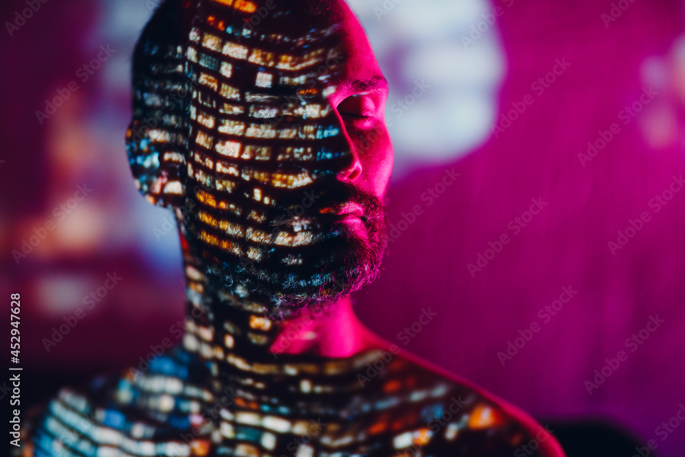 Adult man in the projection of light points on his body Adult man in the projection of light points on his body