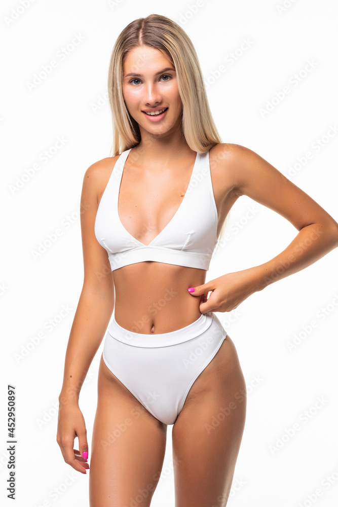 Sexy woman in white lingerie shows off her gorgeous figure isolated on white Sexy woman in white lingerie shows off her gorgeous figure isolated on white