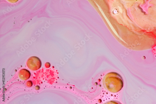 drops of oil on pink or purple background with small pieces of red. drawing some beautiful and suggestive silhouettes. with negative space