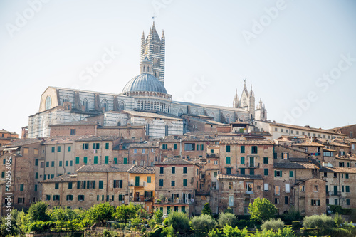 Siena Cathedral (Italian: Duomo di Siena) and panoramic city views. Old historic town in Italian Tuscany