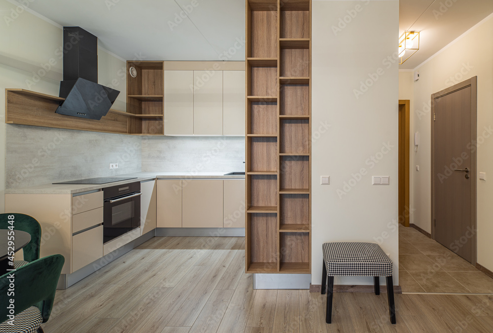 Fototapeta premium Modern light interior of studio apartment. Kitchen. Living room.