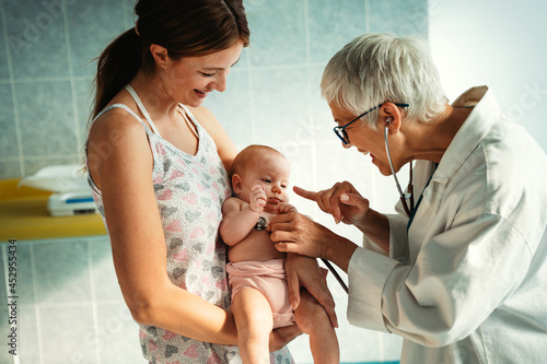 Wallpaper Mural Portrait of happy mother with baby, medical pediatrician doctors, nurse Torontodigital.ca