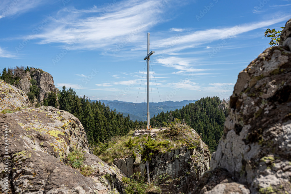 View on coniferous woods and Rocky mountains in Bulgaria with cross on top of it. View on coniferous woods and Rocky mountains in Bulgaria with cross on top of it.