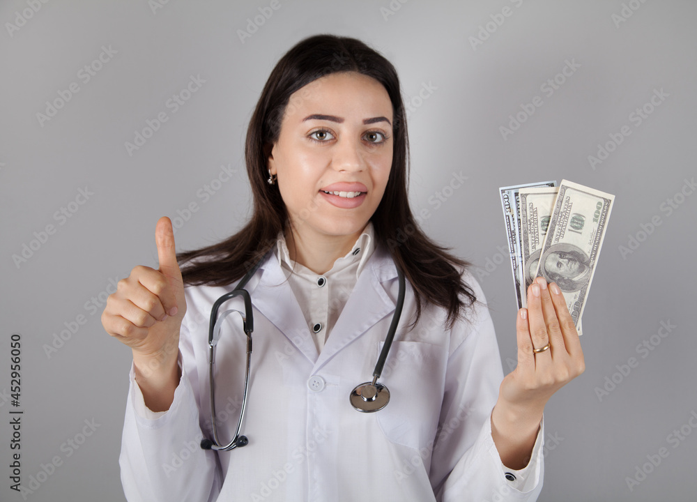 Woman doctor holding a dollar. Corruption or bribe concept. Woman doctor holding a dollar. Corruption or bribe concept.