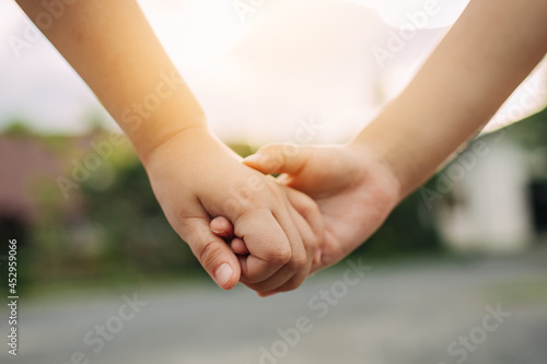 Close up of children hand holding together. Concept for together love and bonding of sibling in family.