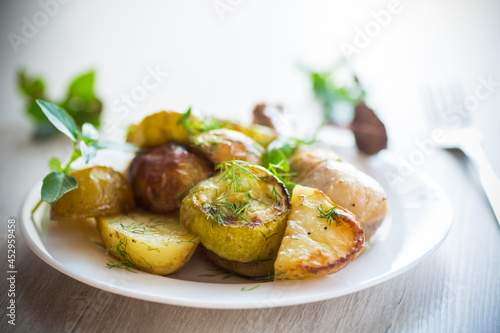 Early baked potatoes with zucchini and chicken