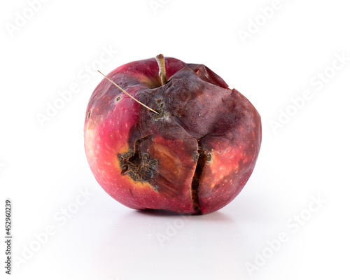 spoiled apple. rotten apple fruit. side view rotten apple on a white background