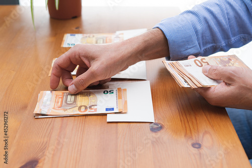 Man distributing money for monthly expenses. Copy space.