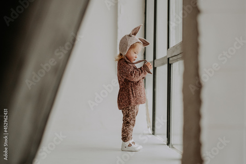 Toddler baby girl in funny hat with ears having fun
