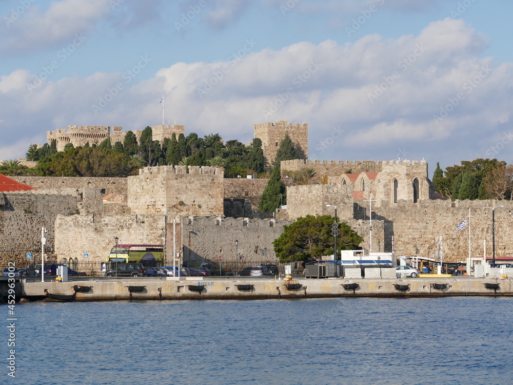 View of the mighty defenses of Rhodes City, Rhodes, Greece, in the background the Palace of the Grand Masters of the Order of St. John
