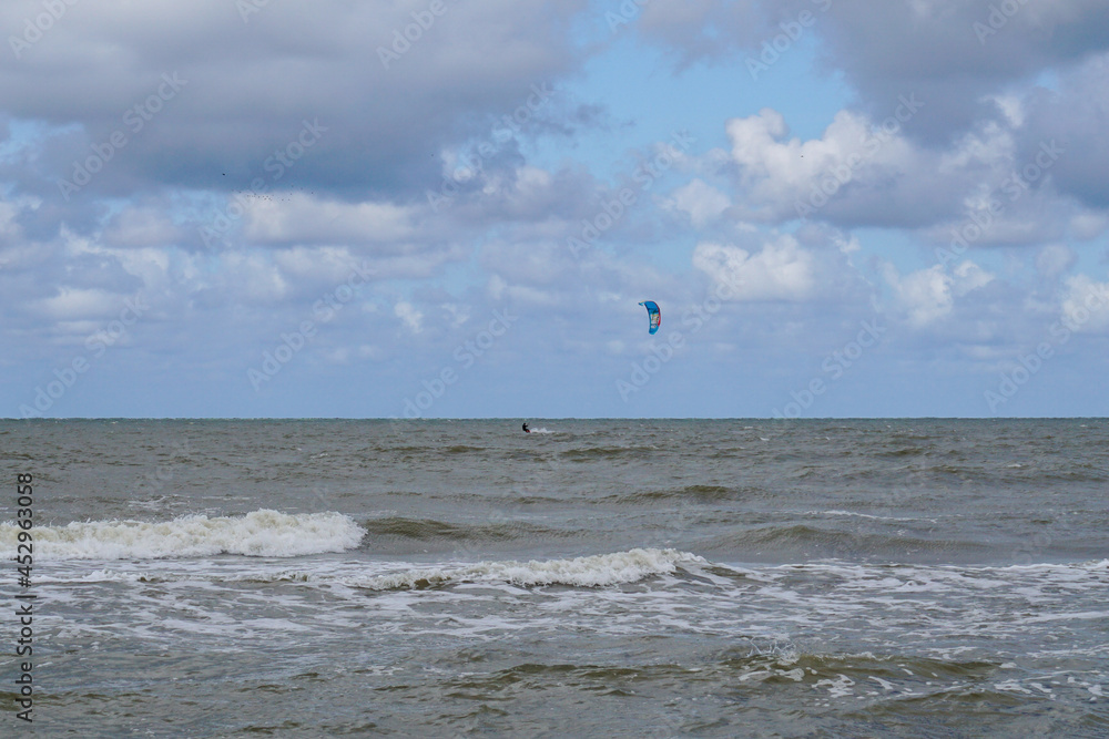 kite surfer enjoys a brisk wind on the Baltic seashore in Pavilosta
