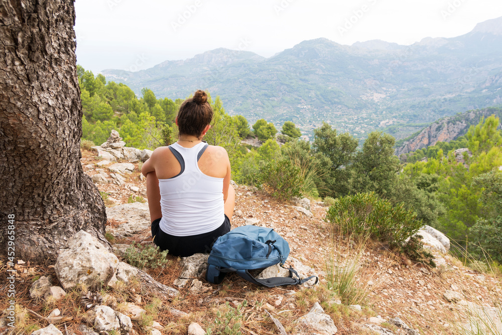 Young girl enjoying the scenery during a hike in the mountains.