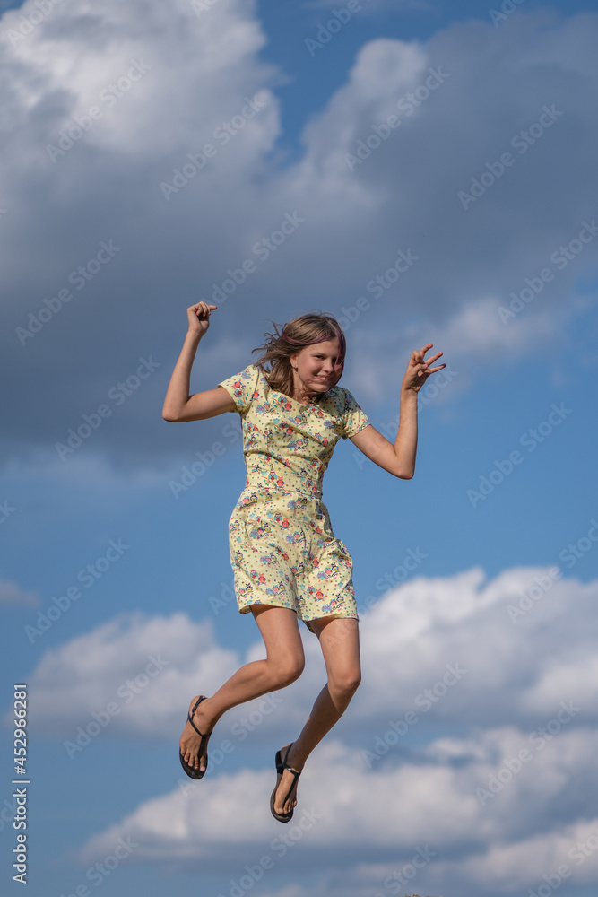 A beautiful girl plays in the field on bales of straw. A beautiful girl plays in the field on bales of straw.