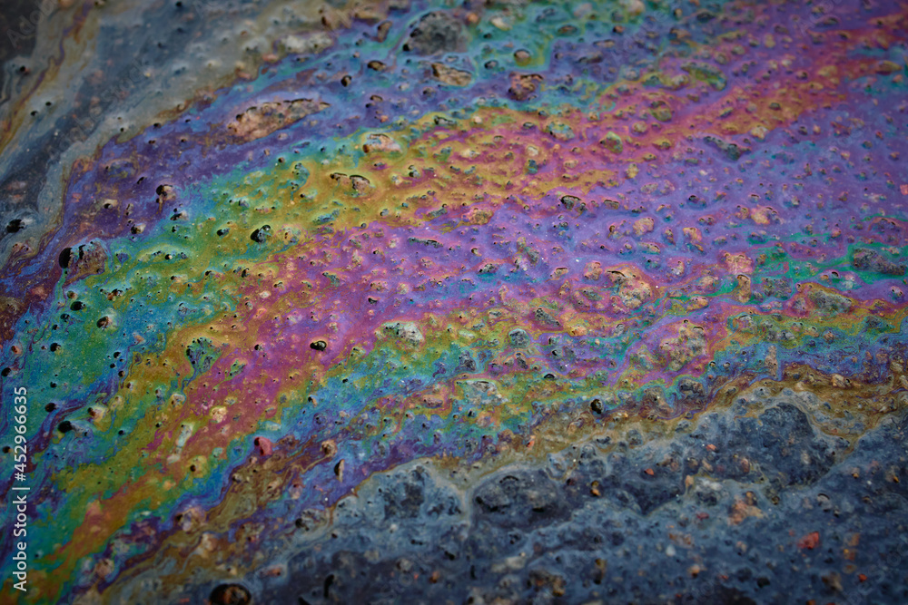 Oil stain on Asphalt, color Gasoline fuel spots on Asphalt Road as Texture or Background