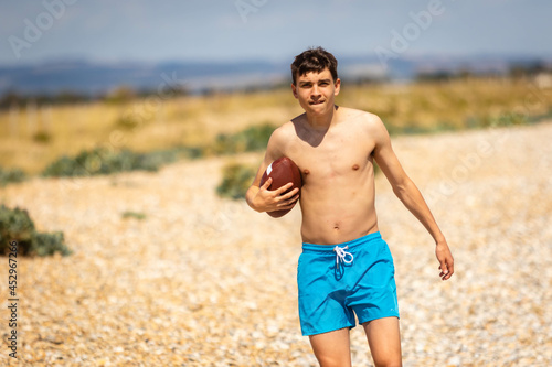 Running on a beach with an American Football