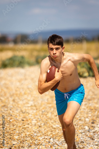 Running on a beach with an American Football
