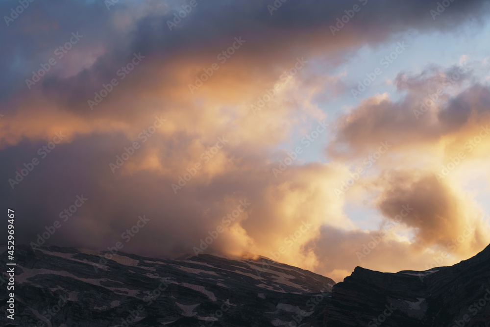Beautiful sunset sky with clouds over the mountain range