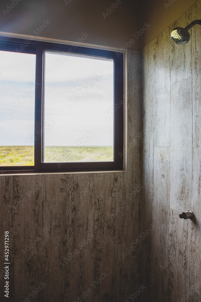 Fototapeta premium A shower with a view through the window in the wall