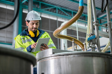 professional inspection control scientist in uniform are working for fruit juice production industry in food manufacturing factory, water drink checking and beverage research in laboratory
