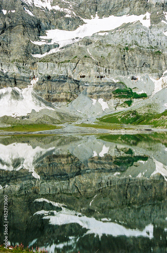 Mirror effect on mountain lac. Infinite snow. Hike in Switzerland.
