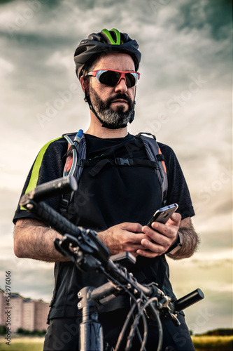 cyclist looking at a route via a mobile phone application
